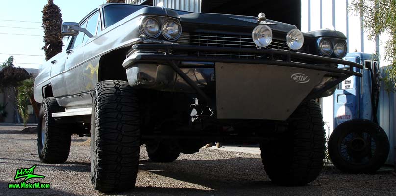 Photo of a 63 Cadillac Sedan deVille that was custom lifted & turned into a 4 Wheel Drive Off Road 4x4 Car. Frontview of a lifted 63 Caddy 4x4 Car