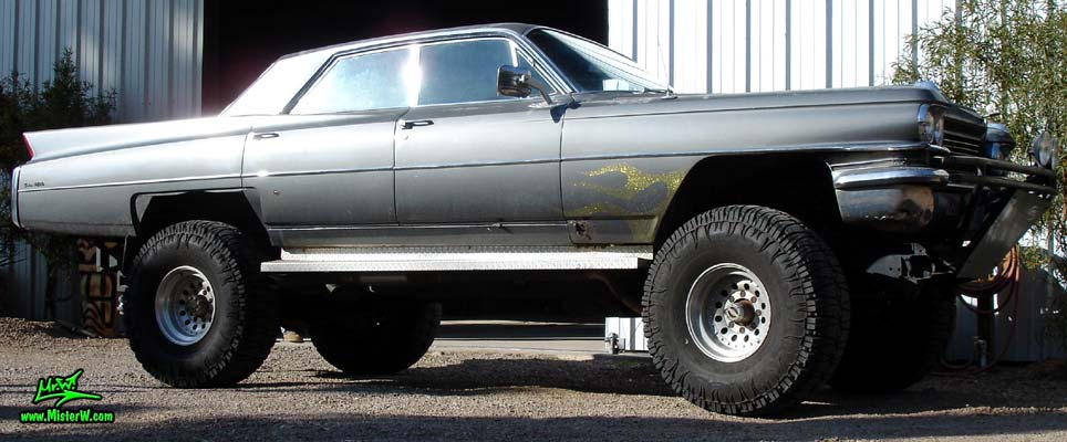 Photo of a 63 Cadillac Sedan deVille that was custom lifted & turned into a 4 Wheel Drive Off Road 4x4 Car. Sideview of a lifted 63 Caddy 4x4 Car