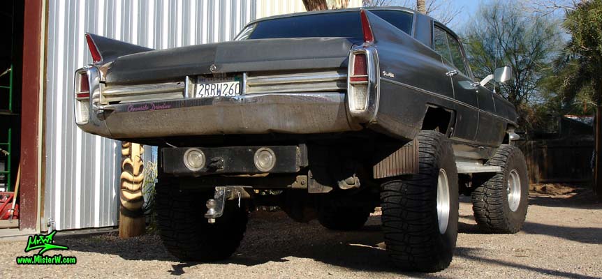 Photo of a 63 Cadillac Sedan deVille that was custom lifted & turned into a 4 Wheel Drive Off Road 4x4 Car. Rearview of a lifted 63 Caddy 4x4 Car