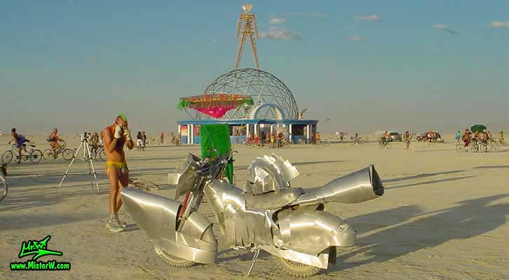 Photo of a silver Art Bike / Mutant Vehicle in Black Rock City, Nevada, 2004. Silver Mutant Art Motorcycle
