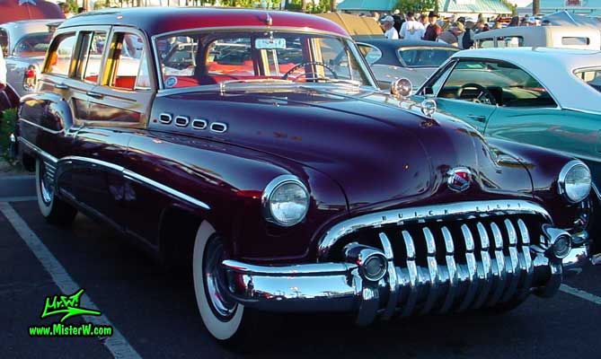 Photo of a maroon Buick Roadmaster Estate wagon, a Woodie station wagon with wood panels at the Scottsdale Pavilions Classic Car Show in Arizona. Side view of a 1950 Buick Roadmaster Station wagon