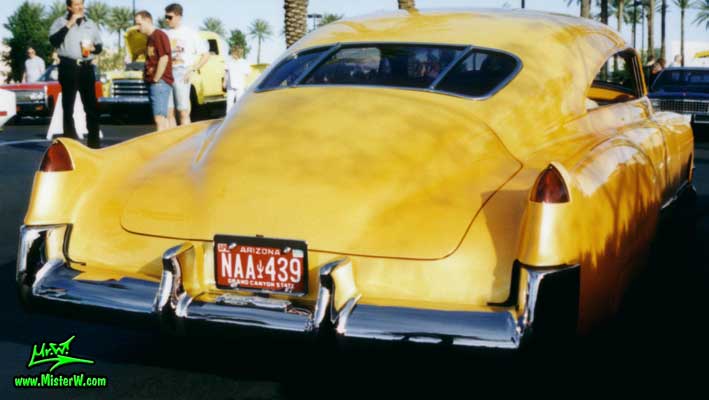 Photo of a powder yellow 1949 Custom Cadillac Sedanet 2 door fastback coupe at the Scottsdale Pavilions Classic Car Show in Arizona. Powder yellow 1949 Cadillac Leadsled