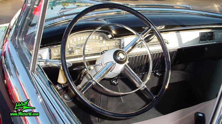 Photo of a black 1950 Cadillac Series 62 Coupe 2 Door Hardtop at the Scottsdale Pavilions classic car show in Arizona. 1950 Cadillac Odometer
