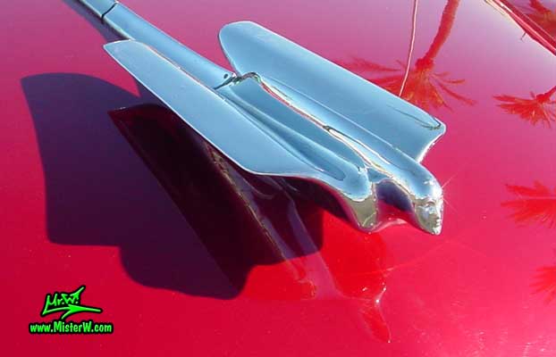 Photo of a cherry red 1950 Cadillac Series 62 4 door sedan at the Scottsdale Pavilions classic car show in Arizona. 1950 Cadillac hood ornament