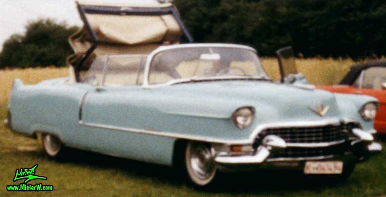 Photo of a turquoise 1955 Cadillac Series 62 Convertible at a classic car meeting in K�ln Chorweiler (Cologne), Germany. 1955 Cadillac Convertible with the top closing