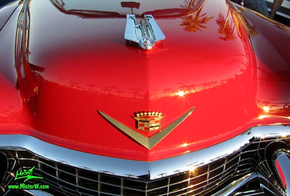Photo of a red 1955 Cadillac Eldorado Convertible at the Scottsdale Pavilions Classic Car Show in Arizona. Chrome Emblem of a 55 Cadillac Eldorado Convertible