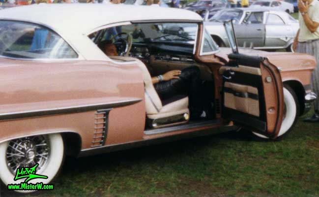 Photo of a pink 1957 Cadillac Coupe 2 Door Hardtop at a classic car meeting in K�ln Chorweiler (Cologne), Germany. 1957 Cadillac Coupe with open door