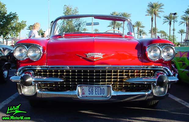 Photo of a red 1958 Cadillac Eldorado Biarritz Convertible at the Scottsdale Pavilions Classic Car Show in Arizona. Chrome grill of a 1958 Cadillac Eldorado Biarritz