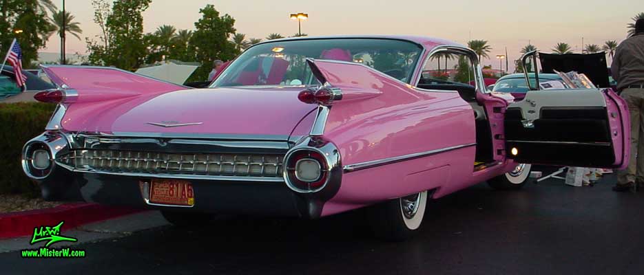 Photo of a pink 1959 Cadillac 2 Door Hardtop Coupe at the Scottsdale Pavilions Classic Car Show in Arizona. 1959 Cadillac Coupe with open Door