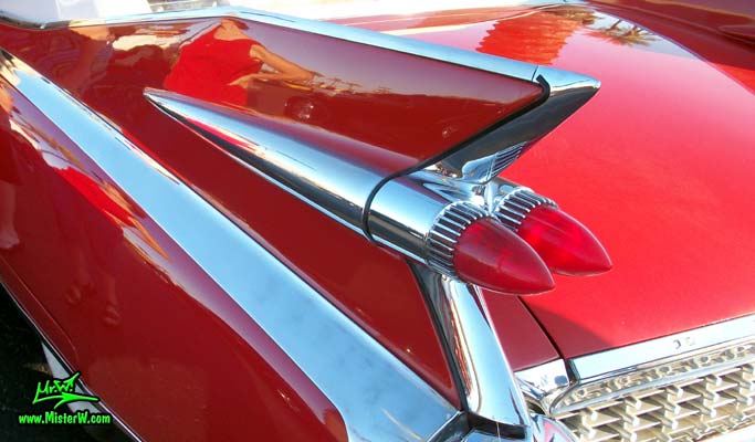 Photo of a red 1959 Cadillac Eldorado Biarritz Convertible at the Scottsdale Pavilions Classic Car Show in Arizona. Tailfin of a 1959 Cadillac Eldorado Biarritz Convertible