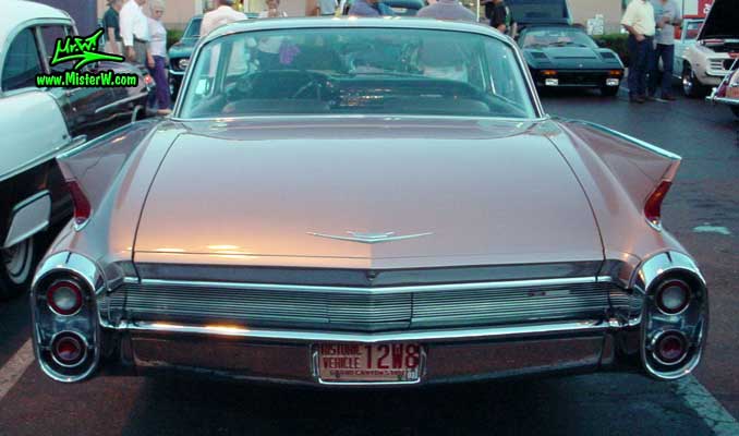 Photo of a pink 1960 Cadillac 2 Door Hardtop Coupe at the Scottsdale Pavilions Classic Car Show in Arizona. 1960 Cadillac Fins