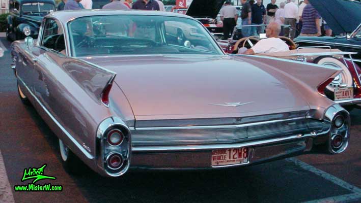 Photo of a pink 1960 Cadillac 2 Door Hardtop Coupe at the Scottsdale Pavilions Classic Car Show in Arizona. 