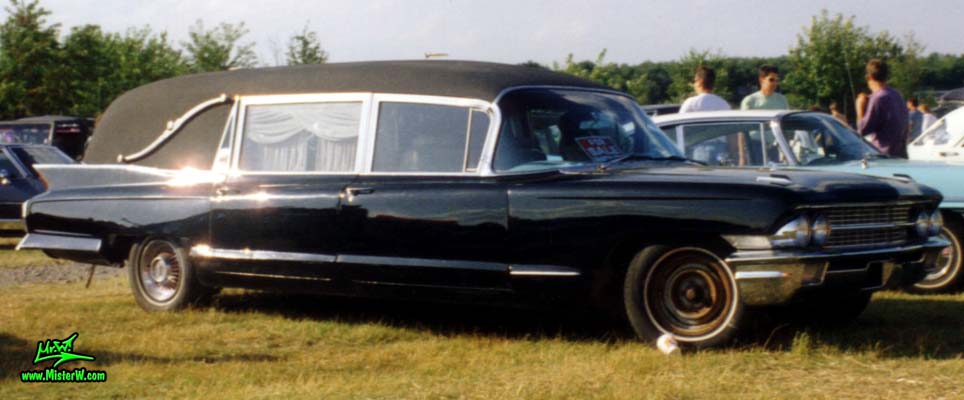 Photo of a black 1962 Cadillac Hearse at a classic car meeting in Germany. 1962 Caddy Hearse Sideview