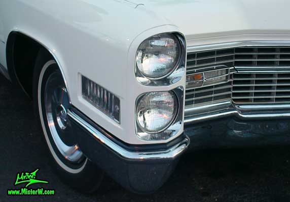 Photo of a white 1966 Cadillac 2 Door Hardtop Coupe at the Scottsdale Pavilions Classic Car Show in Arizona. 1966 Cadillac Head Light