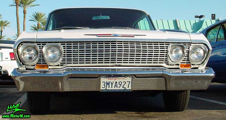 Photo of a white 1963 Chevrolet Impala 2 Door Hardtop Coupe at the Scottsdale Pavilions Classic Car Show in Arizona. Chrome Grill of a 1963 Chevrolet Impala Coupe