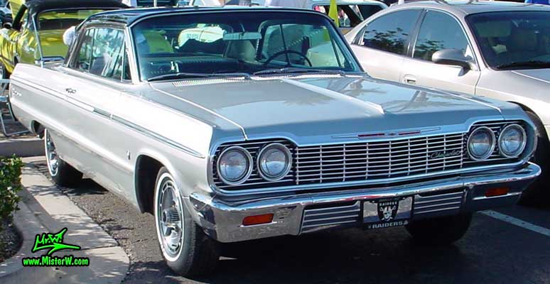 Photo of a silver grey 1964 Chevrolet 2 Door Hardtop Coupe at the Scottsdale Pavilions Classic Car Show in Arizona. 1964 Chevrolet Impala Coupe
