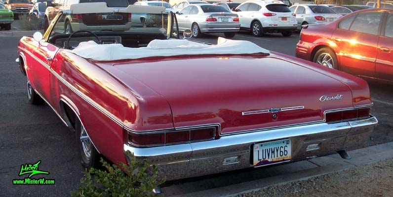 Photo of a red 1966 Chevrolet Impala Super Sport convertible at the Scottsdale Pavilions Classic Car Show in Arizona. 66 Chevy Impala Super Sport convertible tail lights & rear bumper