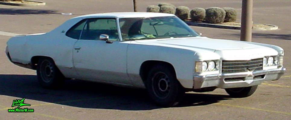 Photo of a beat up white & rusty 1971 Chevrolet 2 door hardtop coupe in Phoenix, Arizona. Sideview of a 1971 Chevrolet Coupe