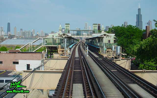 Photo of the Ashland / Lake train station, taken from a green line subway train, above Lake Street in summer 2004 The Ashland / Lake Station & Skyline of Downtown Chicago