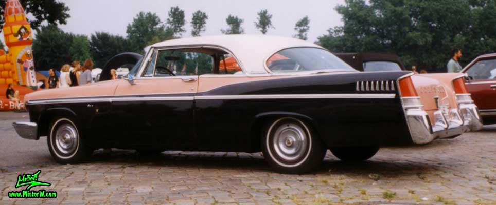 Photo of a pink & black 1956 Chrysler 2 Door Hardtop Coupe at a Classic Car Meeting in Germany. 1956 Chrysler Coupe Tail Fins