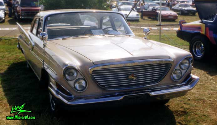 Photo of a tan 1961 Chrysler 4 Door Hardtop Sedan at a classic car meeting in Germany. 1961 Chrysler Sedan Front Grill