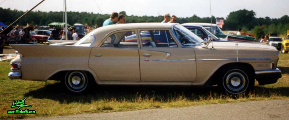 Photo of a tan 1961 Chrysler 4 Door Hardtop Sedan at a classic car meeting in Germany. 1961 Chrysler Sedan Sideview