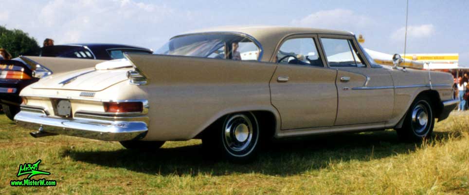 Photo of a tan 1961 Chrysler 4 Door Hardtop Sedan at a classic car meeting in Germany. 1961 Chrysler Sedan Tail Fins