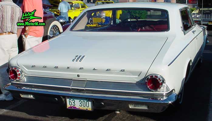 Photo of a white 1963 Chrysler 300 2 Door Hardtop Coupe at the Scottsdale Pavilions Classic Car Show in Arizona. Rearview of a 1963 Chrysler 300 Coupe
