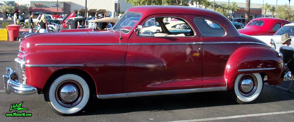 Photo of a red 1948 Dodge 5 Window Coupe at the Scottsdale Pavilions Classic Car Show in Arizona. 48 Dodge 5 Window Coupe Driver Side