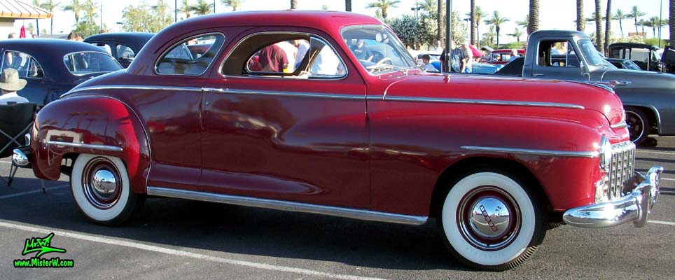 Photo of a red 1948 Dodge 5 Window Coupe at the Scottsdale Pavilions Classic Car Show in Arizona. 48 Dodge 5 Window Coupe Passenger Side