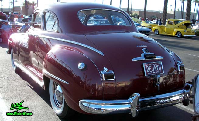 Photo of a red 1948 Dodge 5 Window Coupe at the Scottsdale Pavilions Classic Car Show in Arizona. Rearview of a 1948 Dodge 5 Window Coupe