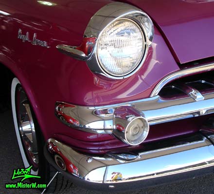 Photo of a Black, Purple & White 1955 Dodge Custom Royal Lancer 2 Door Hardtop Coupe at a Classic Car Auction in Scottsdale, Arizona. Headlight of a 1955 Dodge Custom Royal Lancer Hardtop Coupe