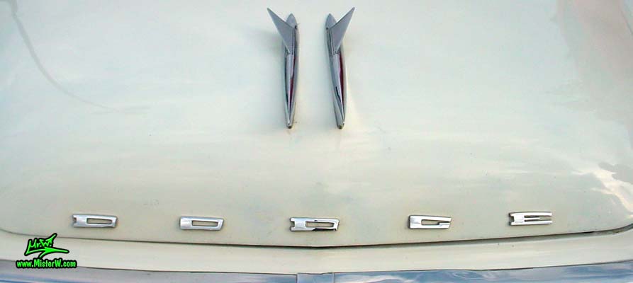 Photo of a white & turquoise 1957 Chrysler Dodge Coronet 2 Door Hardtop Coupe at the Scottsdale Pavilions Classic Car Show in Arizona. 1957 Dodge Hood Ornament & Crome Emblem