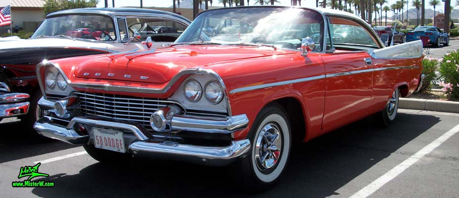 Photo of a red & white 1958 Chrysler Dodge Coronet 2 Door Hardtop Coupe at the Scottsdale Pavilions Classic Car Show in Arizona. Massive Chrome of a 1958 Dodge Coronet