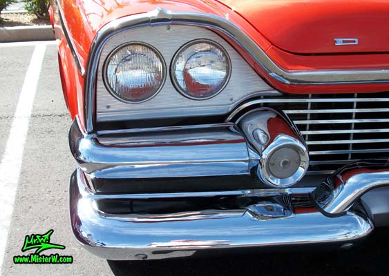 Photo of a red & white 1958 Chrysler Dodge Coronet 2 Door Hardtop Coupe at the Scottsdale Pavilions Classic Car Show in Arizona. Headlight of a 58 Dodge Coronet Coupe