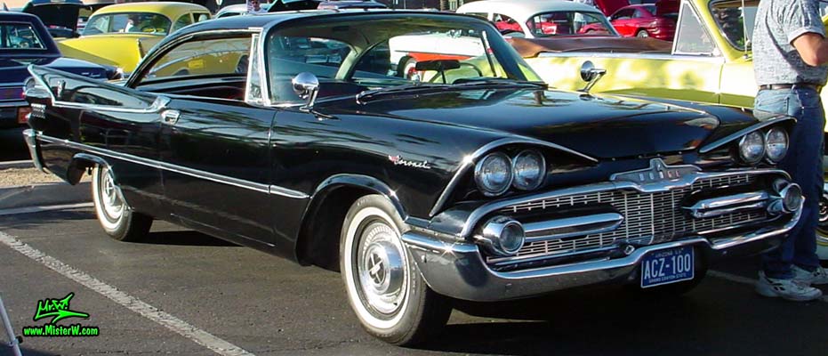 Photo of a black 1959 Chrysler Dodge Coronet 2 Door Hardtop Coupe at the Scottsdale Pavilions Classic Car Show in Arizona. Front Chrome Grill of a 59 Dodge Coupe