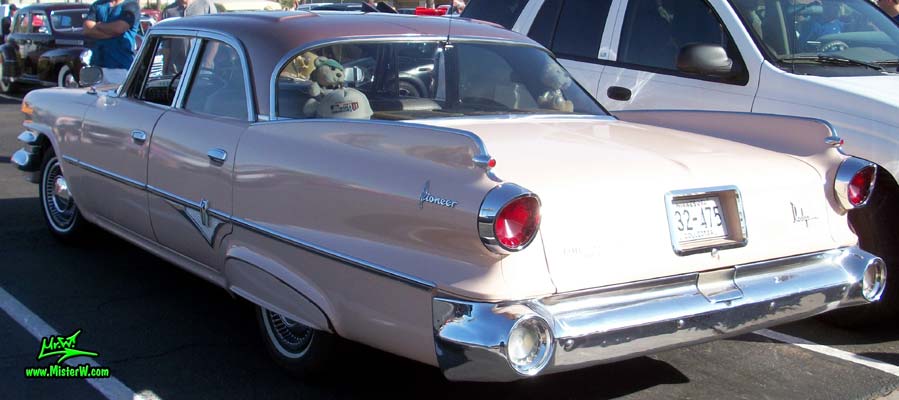Photo of a pink 1960 Dodge Pioneer 4 door sedan at the Scottsdale Pavilions Classic Car Show in Arizona. Tailfins of a 1960 Dodge Pioneer sedan