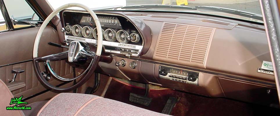 Photo of a brown 1962 Dodge Dart 4 door station wagen at the Scottsdale Pavilions Classic Car Show in Arizona. Dashboard of a 1962 Dodge Dart