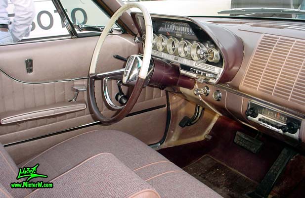 Photo of a brown 1962 Dodge Dart 4 door station wagen at the Scottsdale Pavilions Classic Car Show in Arizona. Interior of a 1962 Dodge Dart station wagen