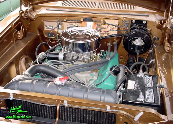 Photo of a brown 1962 Dodge Dart 4 door station wagen at the Scottsdale Pavilions Classic Car Show in Arizona. 1962 Dodge Motor Compartment