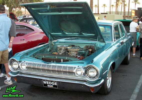 Photo of a blue metallic 1964 Dodge 2 door post coupe at the Scottsdale Pavilions Classic Car Show in Arizona. Frontview of a 1964 Dodge Coupe