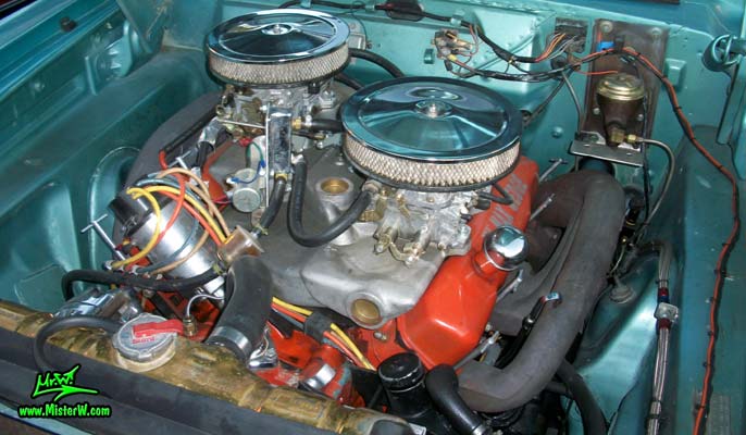Photo of a blue metallic 1964 Dodge 2 door post coupe at the Scottsdale Pavilions Classic Car Show in Arizona. Engine bay of a 1964 Dodge