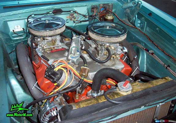 Photo of a blue metallic 1964 Dodge 2 door post coupe at the Scottsdale Pavilions Classic Car Show in Arizona. Motor compartment of a 1964 Dodge coupe