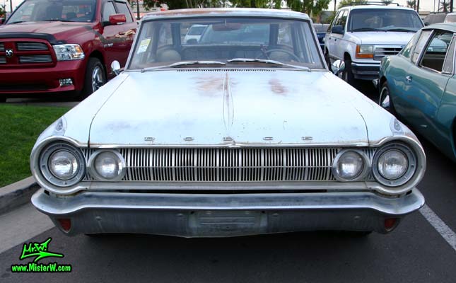 Photo of a bright blue 1964 Dodge 4 door station wagon at the Scottsdale Pavilions Classic Car Show in Arizona. Front view of a 1964 Dodge station wagon