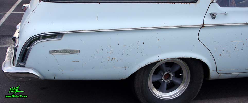 Photo of a bright blue 1964 Dodge 4 door station wagon at the Scottsdale Pavilions Classic Car Show in Arizona. 1964 Dodge station wagon chrome trim & Dodge emblem