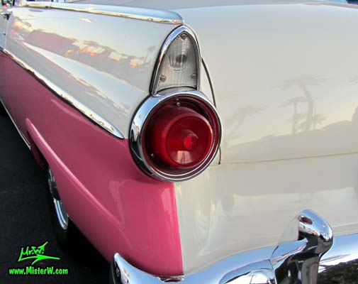 Photo of a pink & white 1955 Ford Crown Victoria 2 Door Hardtop Coupe at the Scottsdale Pavilions Classic Car Show in Arizona. 55 Ford Crown Victoria Coupe Tail Light & Fin