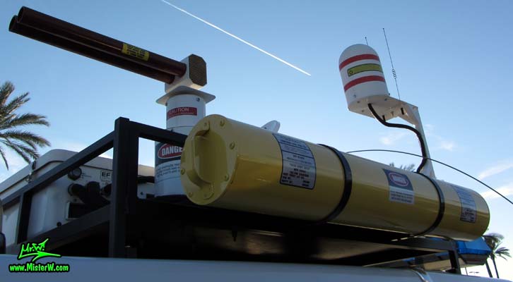 Photo of a red & white Pontiac Ambulance turned into ECTO-AZ the Arizona Ghostbusters Ectomobile at the Scottsdale Pavilions Classic Car Show in Arizona. Arizona Ghost Buster Ectomobile ECTO-AZ Ghostbusters Ecto Roof Rack with Yellow Storage Tube, T.V. Antenna & Marine Radome
