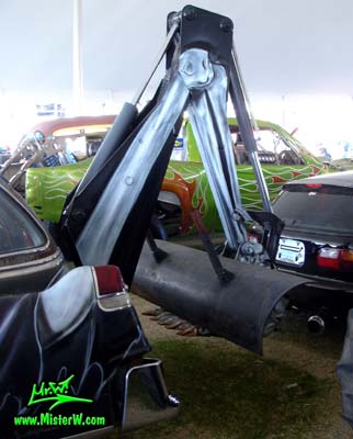 Photo of a black 1954 Cadillac Superior Funeral Coach at a classic car auction in Scottsdale, Arizona. 1954 Cadillac Superior with a backhoe for digging graves