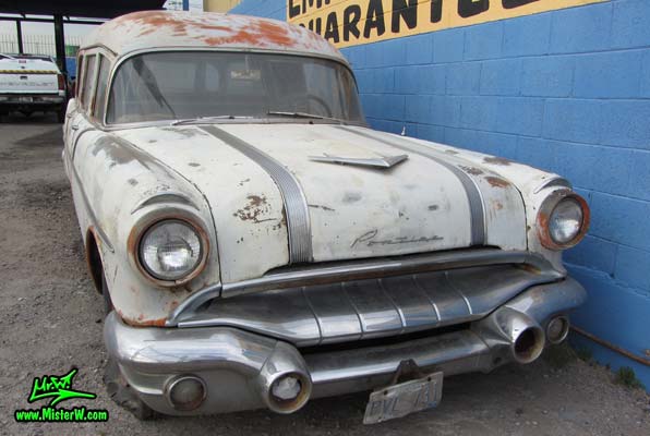 Photo of a faded grey 1956 Pontiac Memphian Ambulance in Phoenix, Arizona. Once painted red & white, in service for the Sheridan Willamina Fire Department in Oregon, build by the Memphian Coach Company in Memphis, Tennessee. Chrome front bumper of a 1956 Pontiac Memphian Ambulance