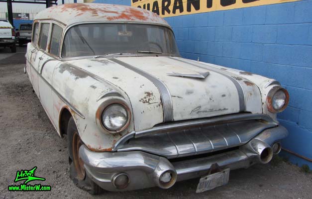 Photo of a faded grey 1956 Pontiac Memphian Ambulance in Phoenix, Arizona. Once painted red & white, in service for the Sheridan Willamina Fire Department in Oregon, build by the Memphian Coach Company in Memphis, Tennessee. Headlights & chrome of a 1956 Pontiac Memphian Ambulance